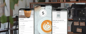 Three smartphones in a coffee shop setting displaying various screens of a coffee ordering app. The center phone features a latte art image with a logo, while the side screens show detailed coffee customization options like milk choices and coffee types.